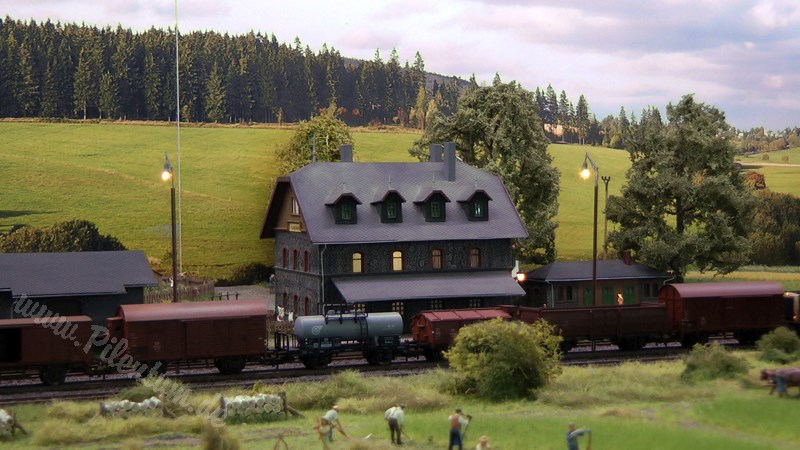 Model railway with station and very realistic landscape in HO scale