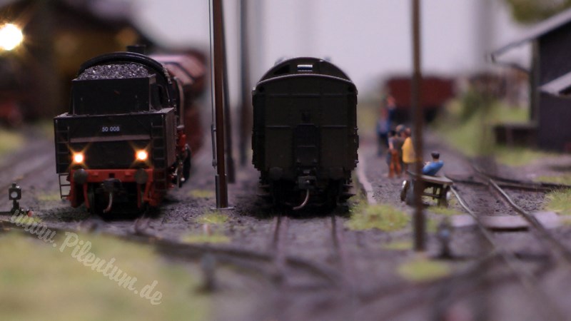 Model railway with station and very realistic landscape in HO scale