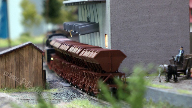 Model railway with station and very realistic landscape in HO scale