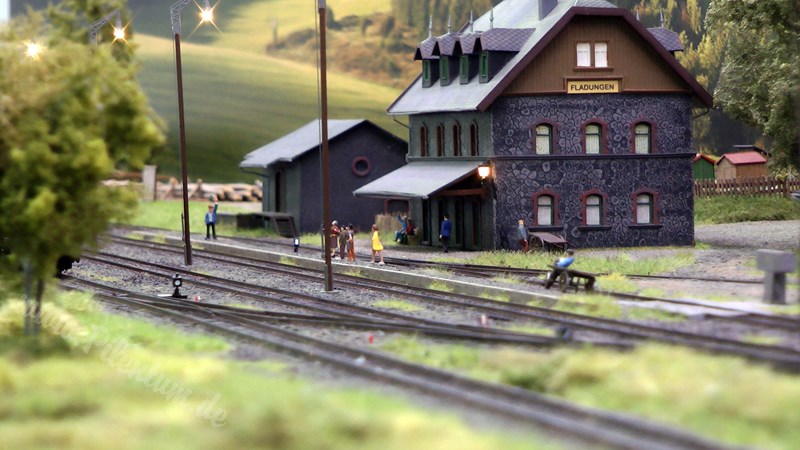 Model railway with station and very realistic landscape in HO scale