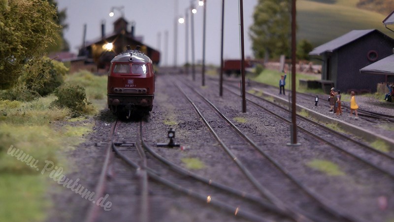 Model railway with station and very realistic landscape in HO scale