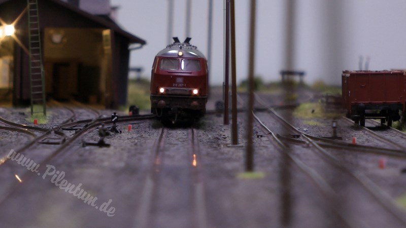 Model railway with station and very realistic landscape in HO scale