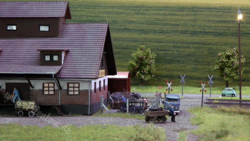 Model railway with station and very realistic landscape in HO scale