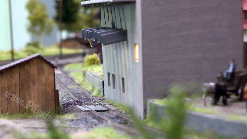 Model railway with station and very realistic landscape in HO scale