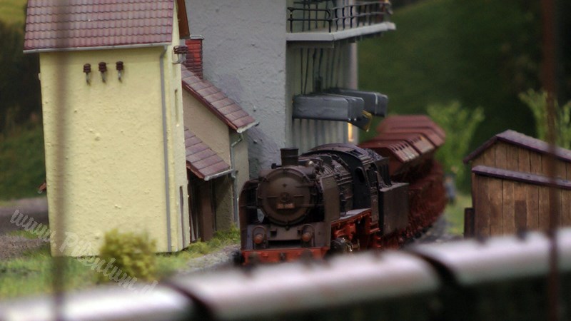 Model railway with station and very realistic landscape in HO scale