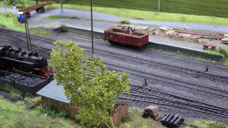 Model railway with station and very realistic landscape in HO scale