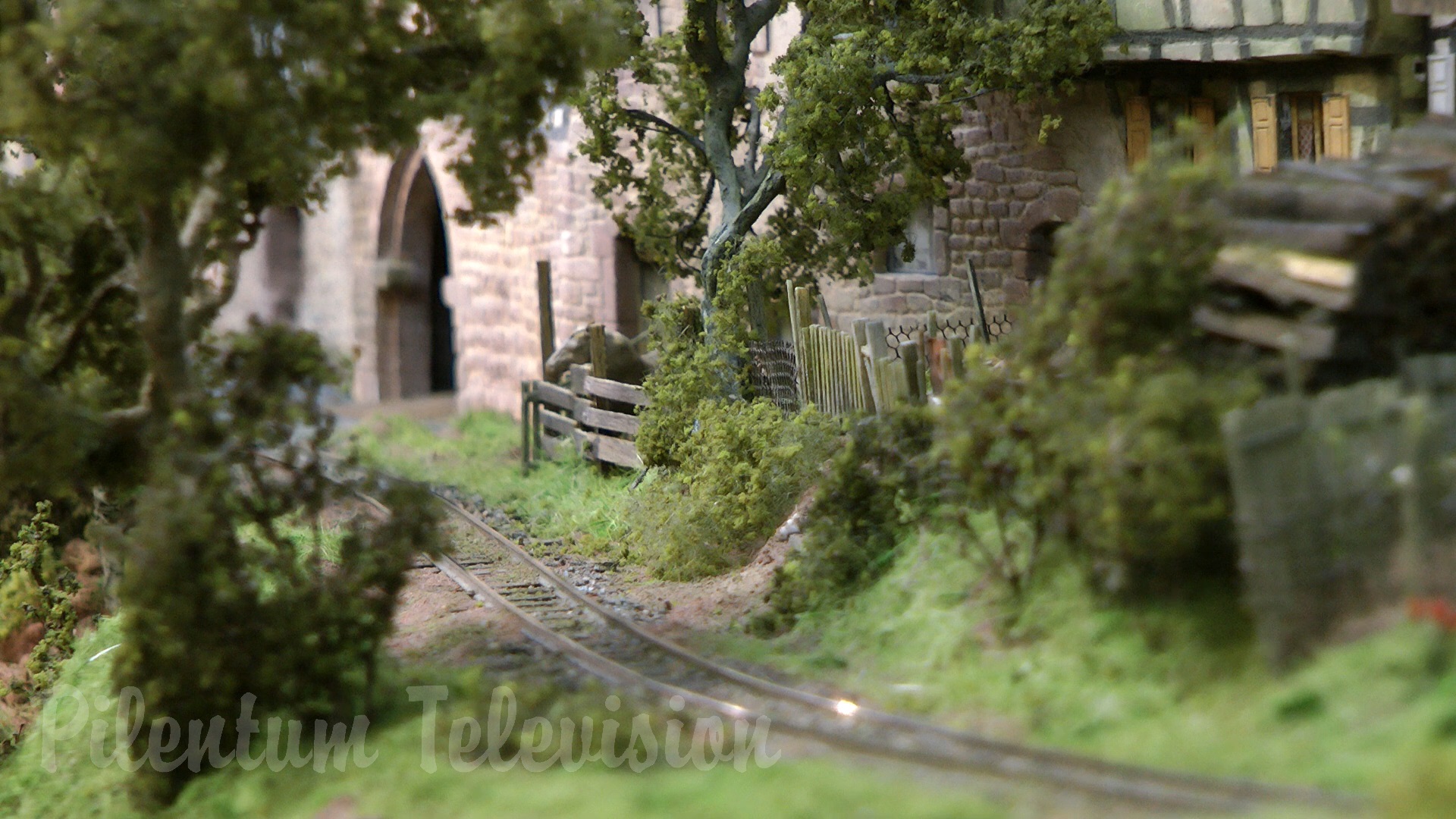 The little steam train inside a realistic built model railway landscape in HO scale