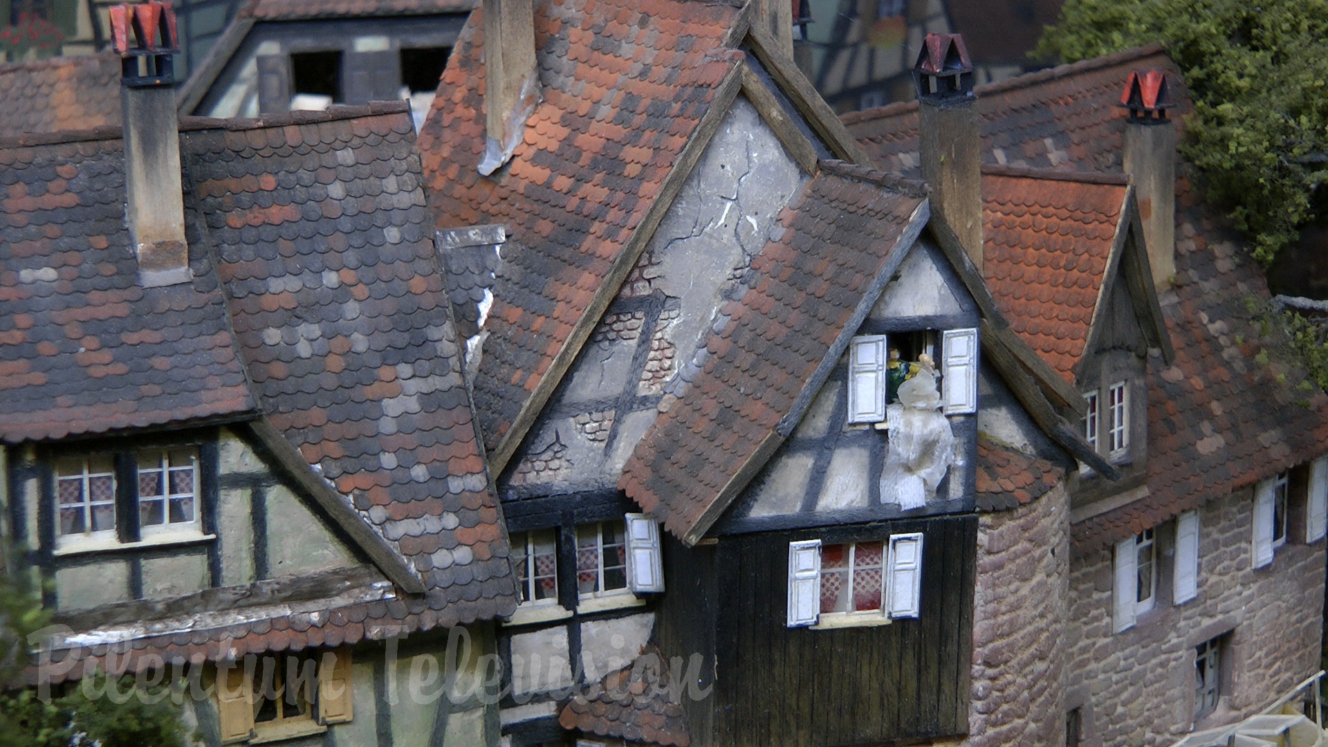 The little steam train inside a realistic built model railway landscape in HO scale