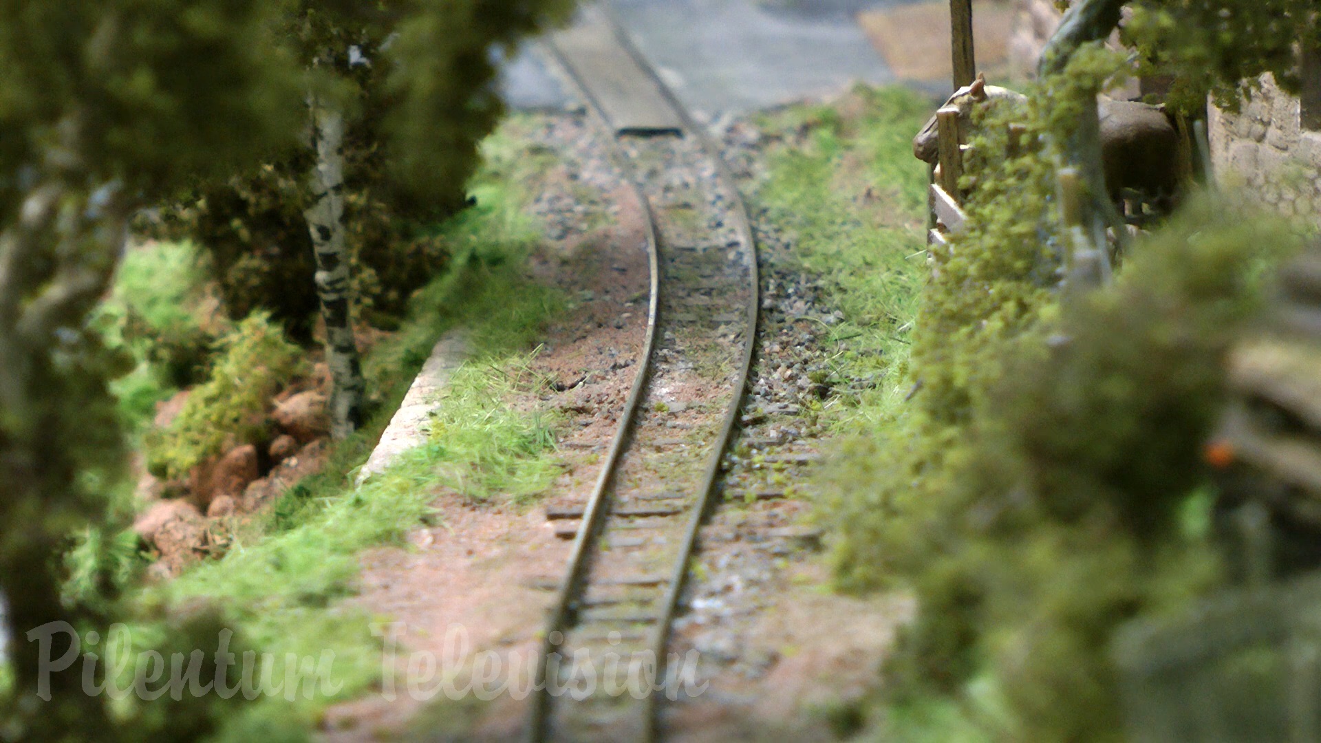 The little steam train inside a realistic built model railway landscape in HO scale