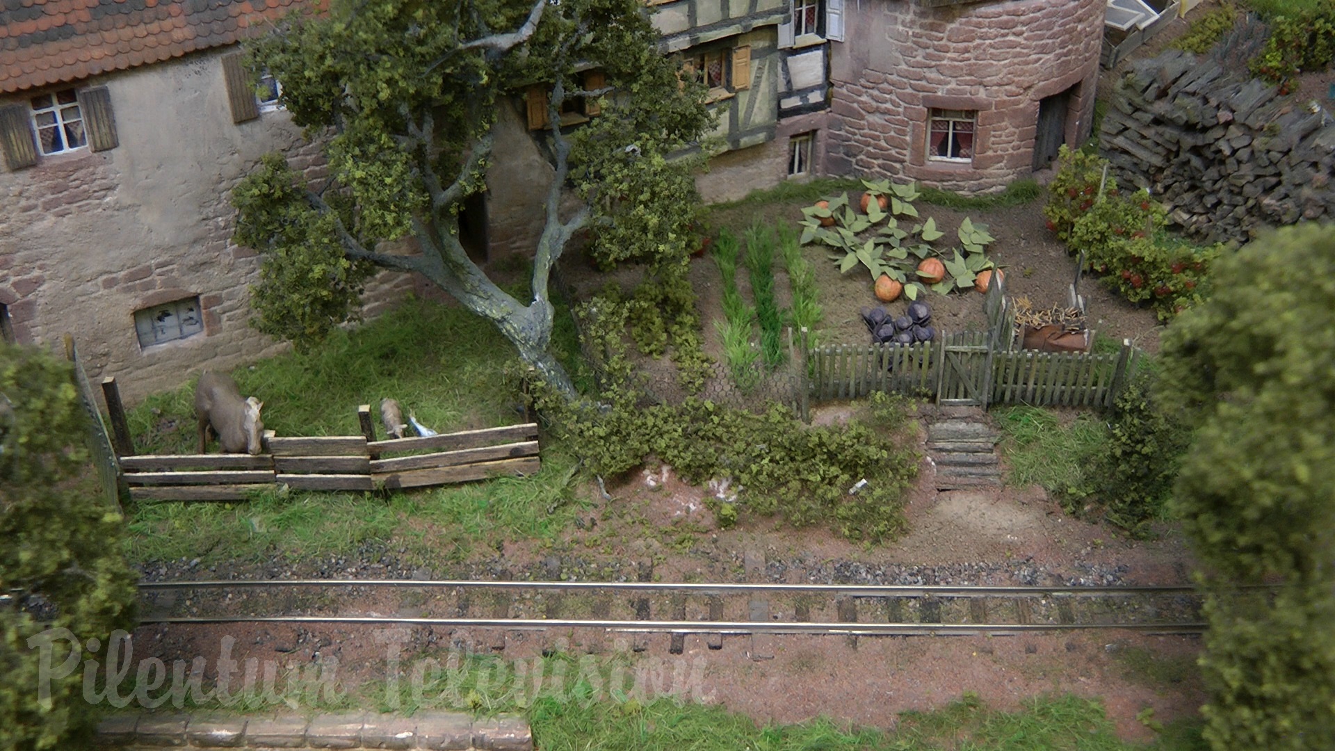 The little steam train inside a realistic built model railway landscape in HO scale