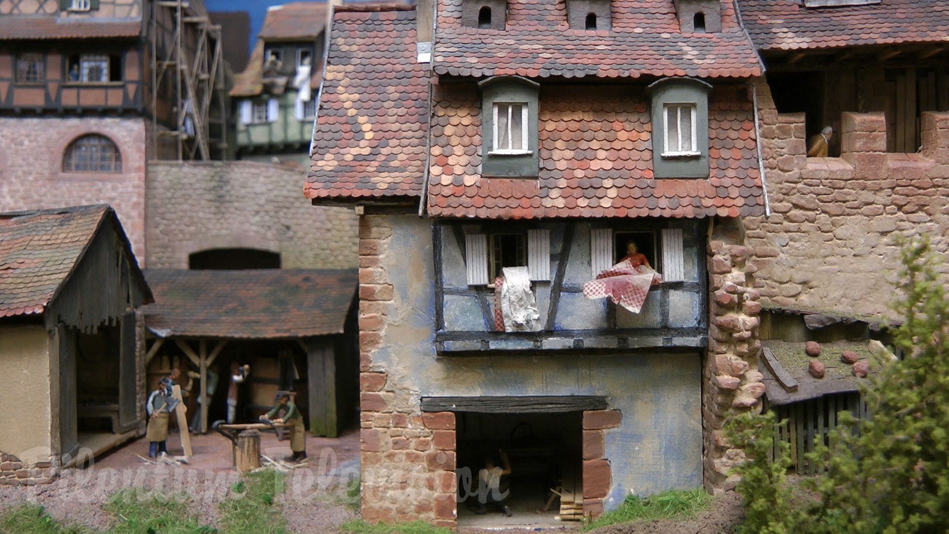 The little steam train inside a realistic built model railway landscape in HO scale